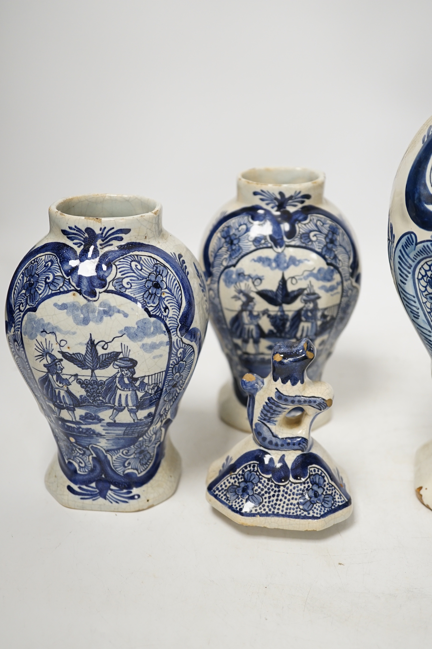 An 18th century Delft blue and white vase and a pair of later Delft vases and covers, tallest 23.5cm